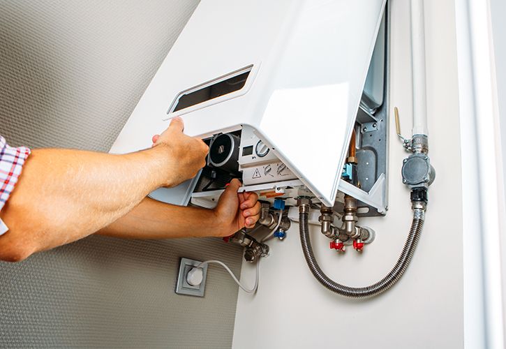 Plumber boiler heating engineer shutterstock_1821023261