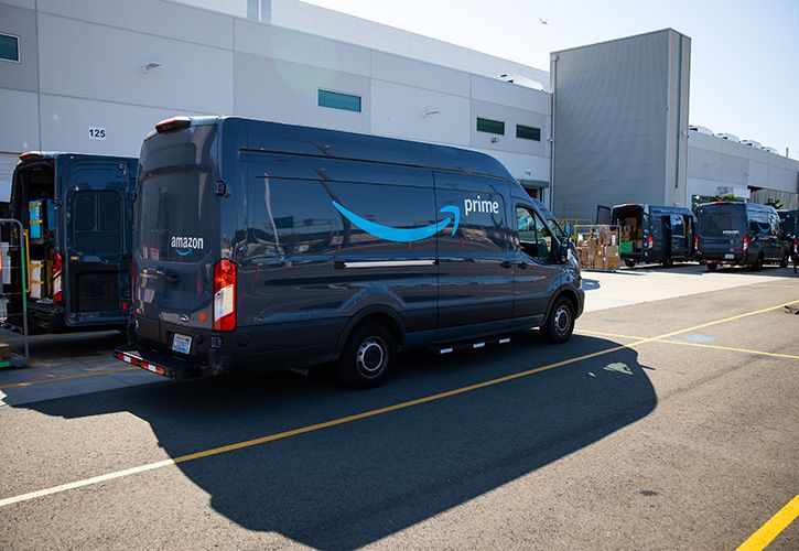 Amazon delivery vans in loading lot area