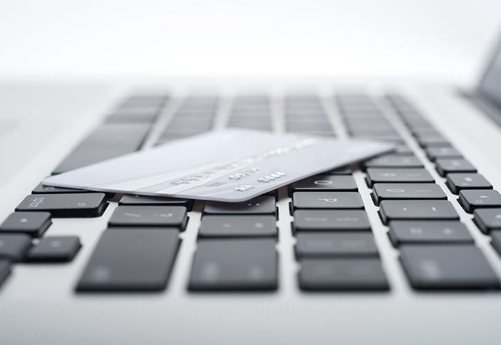 Laptop and card - NCR - shutterstock_116422102 725 x 500