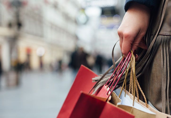 Female shopper carrying bags shutterstock_357891440 725 x 500.jpg